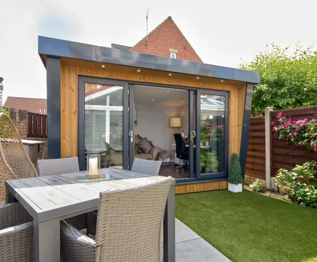 Garden studio with anthracite sliding patio doors and overhang